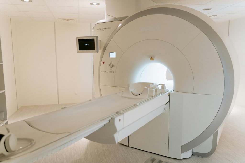 pexels-photo-7089017-7089017 A state-of-the-art MRI scanner in a well-lit hospital room, ready for patient use.